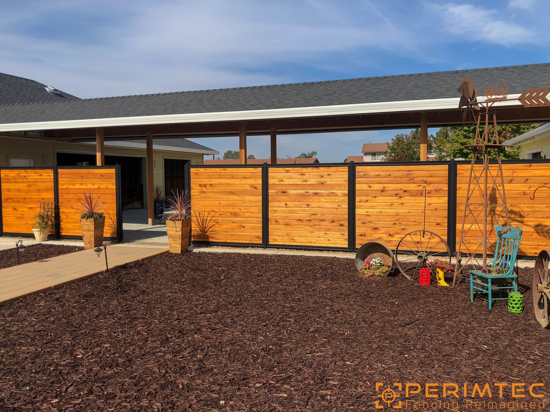 Horizontal wood slat fence infill installed inside a steel frame system.